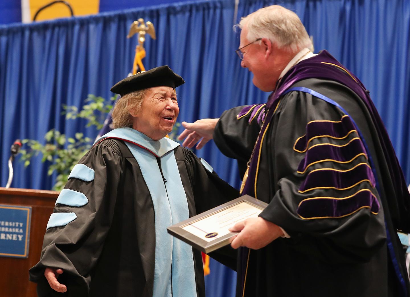 UNK Chancellor Doug Kristensen presents the Leland Holdt/Security Mutual Life Distinguished Faculty Award to Patricia Hoehner during the winter commencement ceremony in December 2023.