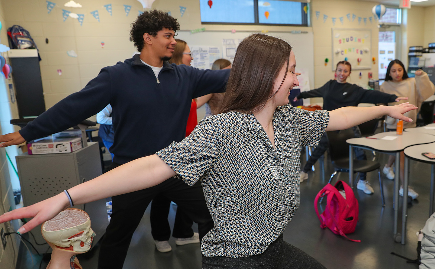 UNK senior Sam Burns, front, and other members of the social work student ambassador program lead a self-care exercise during a recent visit to Kearney High School. (Photo by Erika Pritchard, UNK Communications)