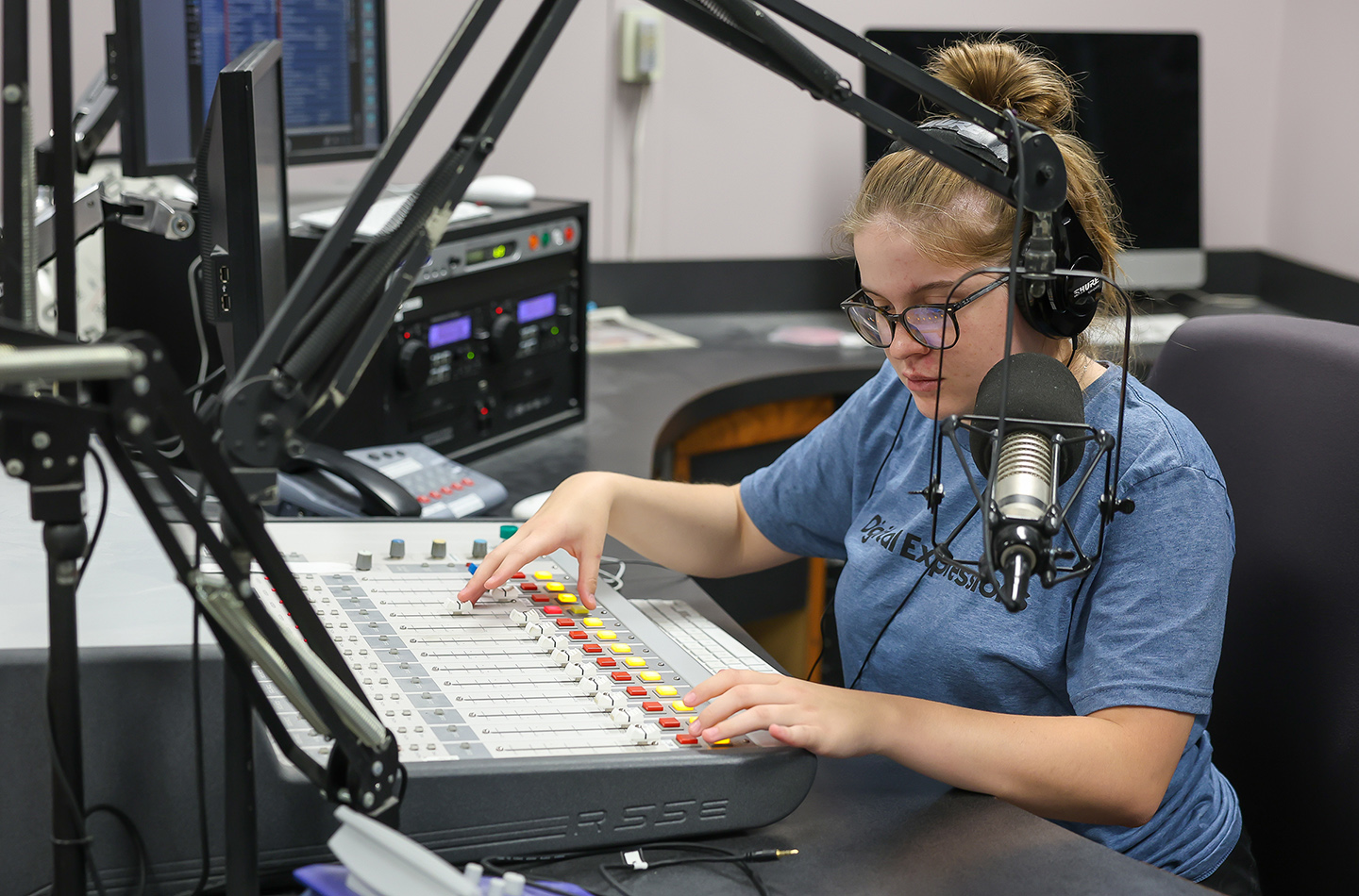 Linley Fegley of Cambridge runs the soundboard in the UNK radio studio during the Digital Expressions Media Camp.