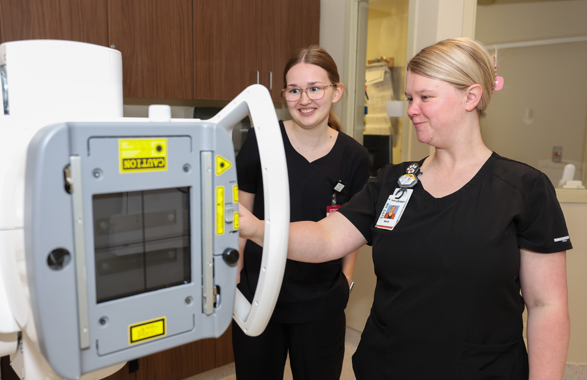 Brett Zink, right, a radiologic technologist at Sidney Regional Medical Center, shows UNK sophomore Alexys Hurt some of the equipment in the radiology department.