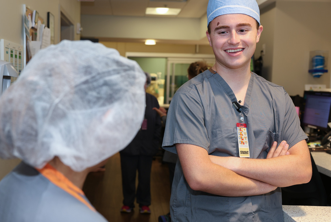 UNK pre-medical student Brodie Mitchell chats with a health care professional at Sidney Regional Medical Center while participating in the Rural Immersion Program.