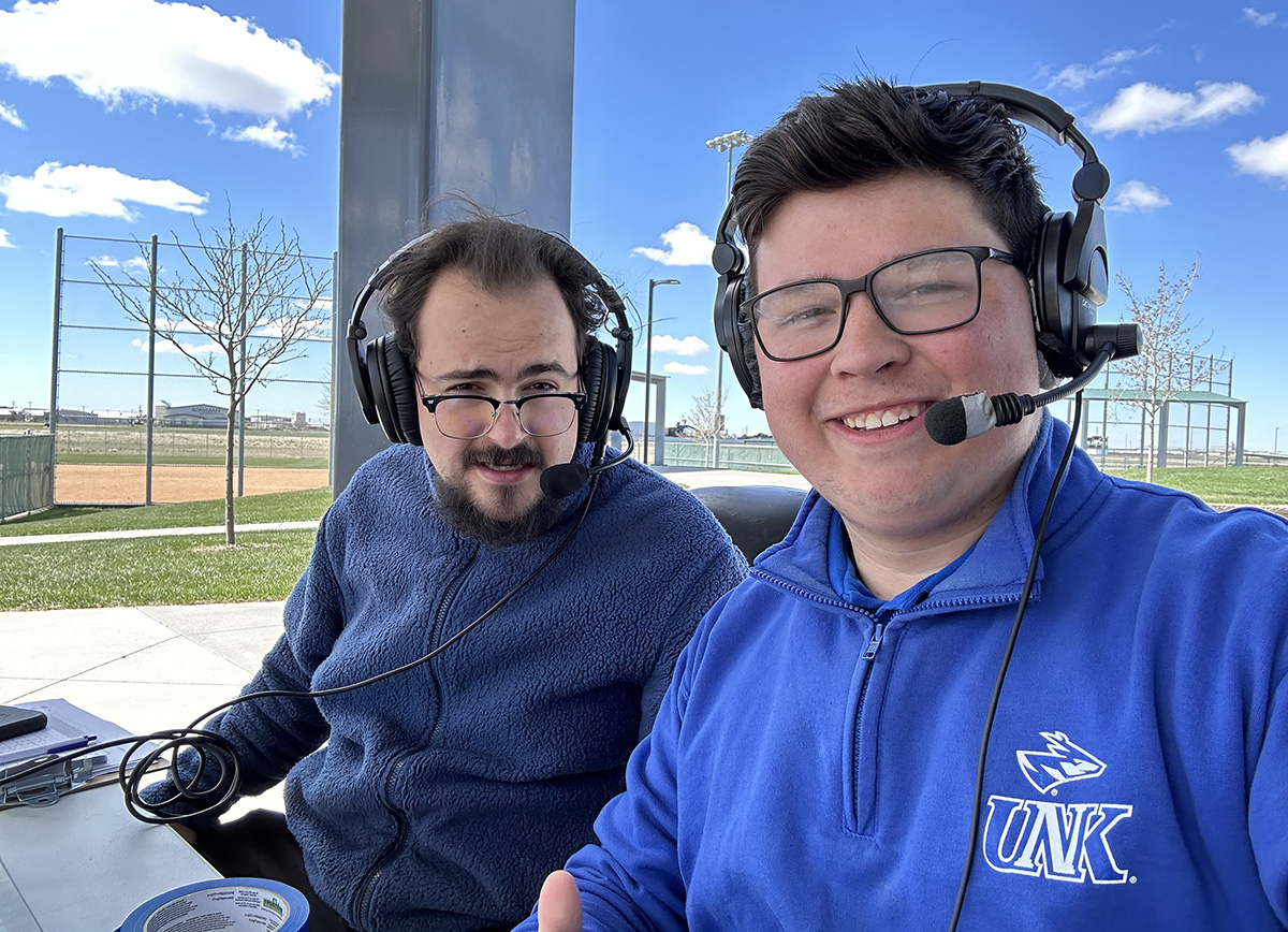 Alex Hammeke, left, called games for several Loper athletic teams during his time at UNK. He’s pictured with fellow KLPR sports staff member Jon Willis. “The experience that I was able to gain here basically fast-tracked where I am professionally within radio.” (Courtesy photo)