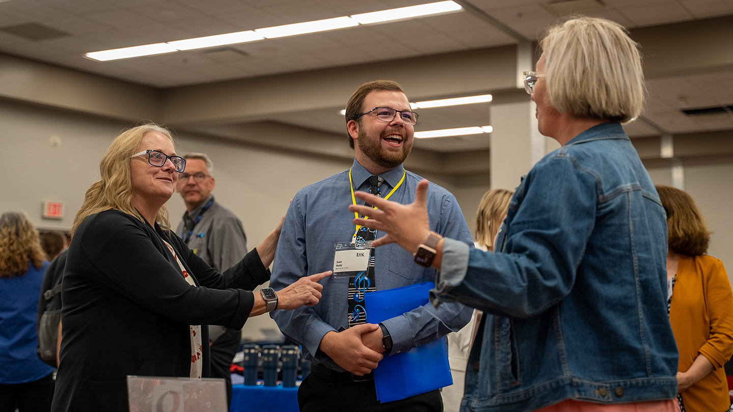 UNK senior Sam Heitz, center, graduates next spring with a degree in music education. He attended Thursday’s Education Opportunities Fair to start building connections with Nebraska school districts. (Photos by Kollin Goff, UNK Communications)