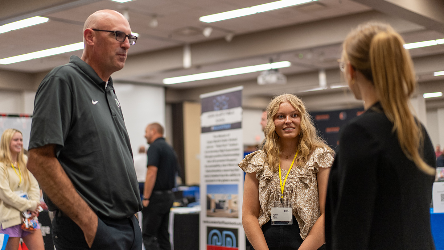 UNK student Alyssa Moes, center, meets with Schuyler Elementary Principals Bill Comley and Alicia Keairnes during Thursday’s Education Opportunities Fair on campus.