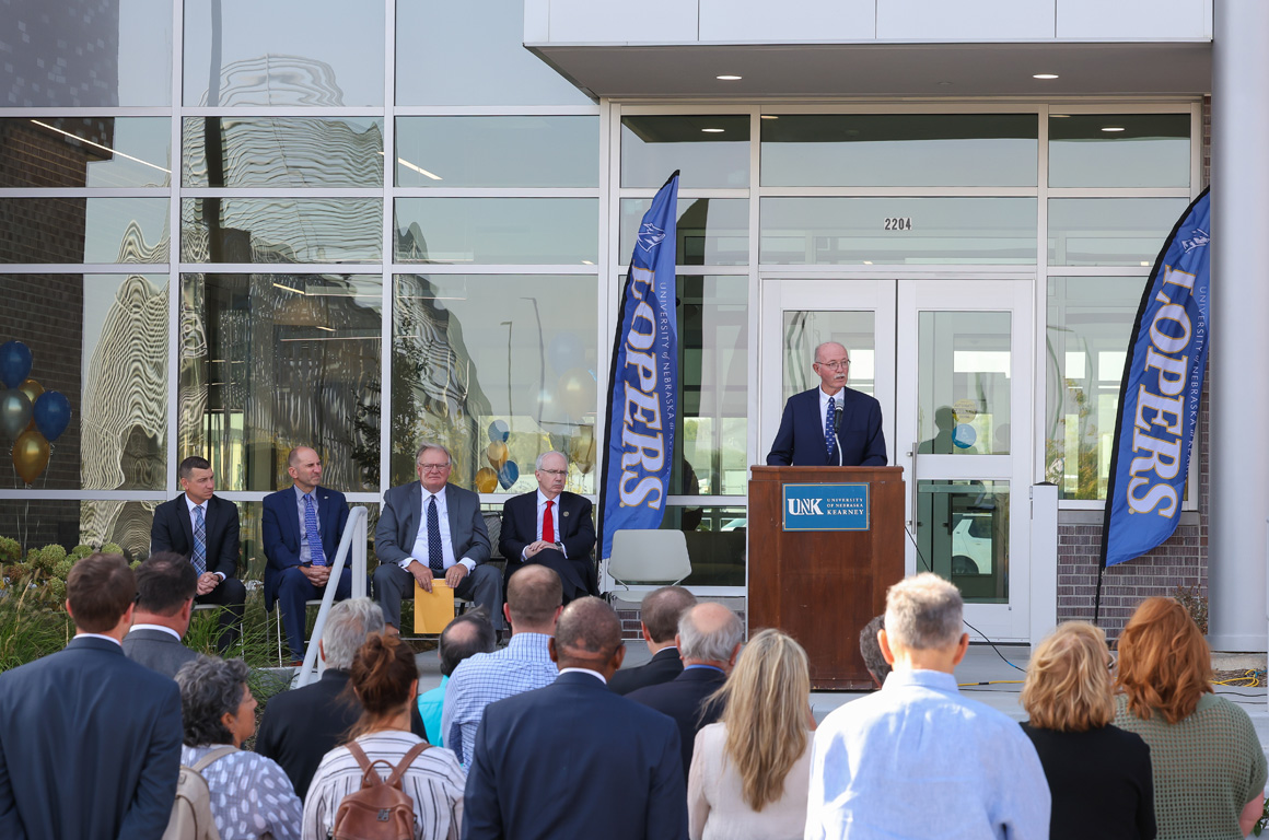 UNK interim Chancellor Charlie Bicak addresses the crowd during Thursday's ribbon-cutting ceremony at the new Regional Engagement Center.