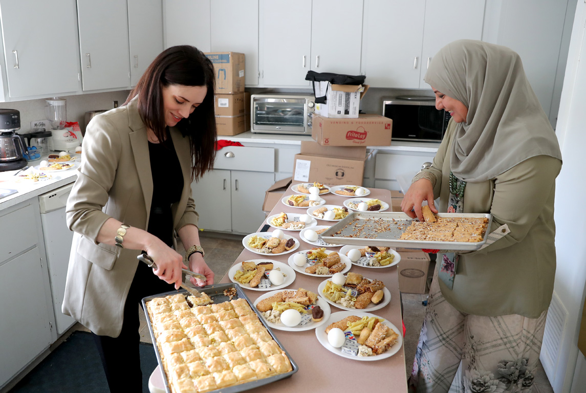 UNK associate professor Tiffani Luethke, left, and MENA Hope Project Coordinator Zainab Al-Baaj prepare for a celebration at the Good Neighbor Community Center in Lincoln. The event culminated an eight-week research project focusing on Middle Eastern and North African immigrants.