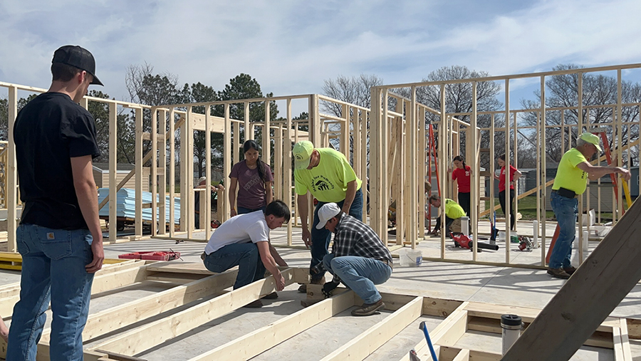 Members of the UNK Construction Management Organization assist with a Habitat for Humanity build earlier this semester.