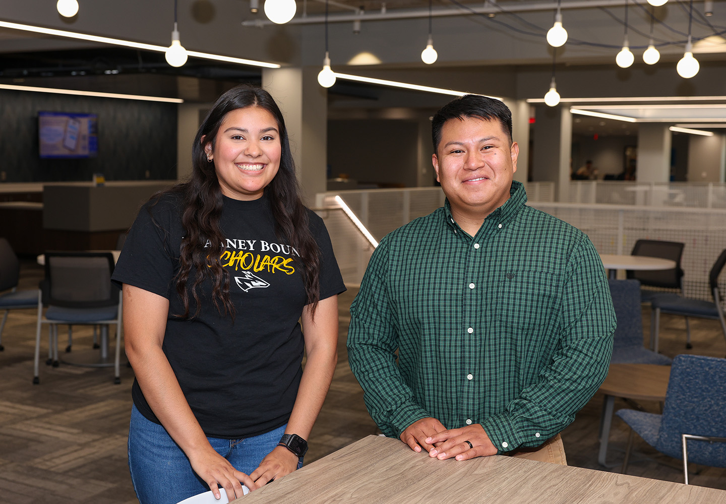 UNK junior Yanilet Montano and Kearney Bound coordinator Abel Virgilio pose for a photo inside the Loper Success Hub on campus. Montano is a peer mentor in the Kearney Bound program, which supports first-generation students from high school through college graduation. (Photo by Erika Pritchard, UNK Communications)