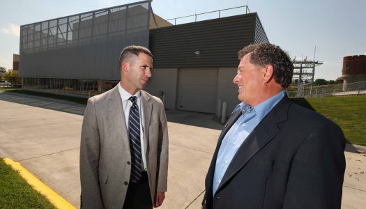 UNK’s Jon Watts, left, and NPPD’s Stan Clouse discuss the agreement that soon will give the university 25 percent of its electrical energy from the new $11 million solar park being built in Kearney. (Photo by Corbey R. Dorsey/UNK Communications)
