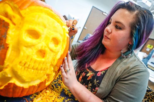 University of Nebraska at Kearney student Autumn Castellanos of Cozad carves a pumpkin Monday for an annual contest on campus among fine arts students and others. (Photo by Corbey R. Dorsey, UNK Communications)