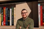 Kearney artist Josh Arias, a UNK alumnus, grew up in poverty in Los Angeles before moving to Lexington in the late 1990s. He has helped create many public murals, including the giant books on the west side of Kearney Public Library, 2020 First Ave. (Photo by Corbey R. Dorsey, UNK Communications)