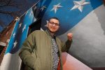 UNK alumnus Josh Arias has helped create a number of public murals in central Nebraska, including the American flag on the Kearney VFW Club at 2215 First Ave. (Photo by Corbey R. Dorsey, UNK Communications)