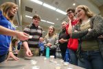 UNK junior Shyann Cochrane, left, leads an “odor identification” activity Tuesday during a psychology fair in the Nebraskan Student Union Ponderosa Room. Only a couple of high schoolers correctly identified all of the mystery scents. (Photo by Corbey R. Dorsey, UNK Communications)