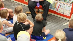 University of Nebraska at Kearney reads one of his favorite books, "Oh, The Places You'll Go" by Dr. Suess, to a group of students Monday at PAWS University's Reading Academy. (Photo by Corbey R. Dorsey, UNK Communications)