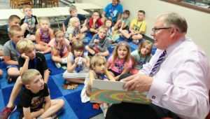 University of Nebraska at Kearney reads one of his favorite books, "Oh, The Places You'll Go" by Dr. Suess, to a group of students Monday at PAWS University's Reading Academy. (Photo by Corbey R. Dorsey, UNK Communications)