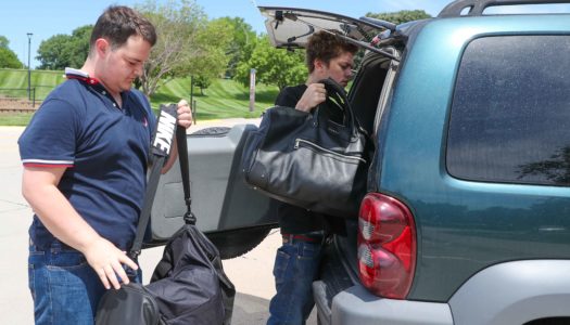 Logan Jeffers, left, of Omaha and Tyler Tracy of Kearney load up their belongings Friday awhile moving out of UNK’s Centennial Towers West residence hall. The two were among more than 330 people who occupied rooms at UNK and received meals after flooding hit the city. (Photo by Corbey R. Dorsey, UNK Communications)