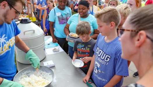 Jared Hunke, a senior from Holdrege, makes ice cream using liquid nitrogen to promote the UNK Chemistry Club during Friday’s Blue Gold Community Showcase on the UNK campus. (Photo by Corbey R. Dorsey, UNK Communications)