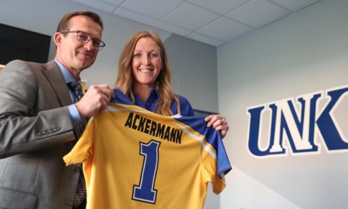 UNK Athletic Director Marc Bauer, left, presents a jersey to new Loper softball Head Coach Katie Ackermann at Wednesday night's news conference. (Photo by Corbey R. Dorsey, UNK Communications)