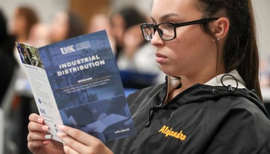 Fremont High School student Alejandra Pena reads a handout Tuesday while visiting the UNK campus. Pena and 44 other Fremont High students traveled to UNK to tour the campus and learn about the supply chain management and industrial distribution programs. (Photo by Corbey R. Dorsey, UNK Communications)