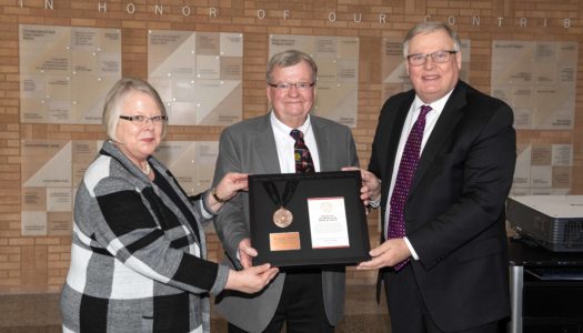 Tom Henning of Kearney, middle, receives the NU Presidential Medal of Service from UNK Chancellor Doug Kristensen and University of Nebraska Interim President Susan Fritz.