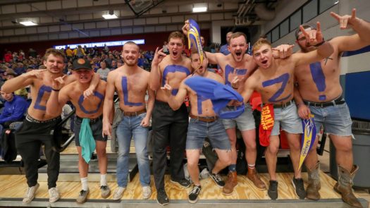 Brockton Sterling, fourth from left, and his Colorado School of Mines football teammates cheer for his sister, Bailee, and the Loper volleyball team at Saturday’s national championship. “We don’t mind being Lopers for a few hours this weekend. It’s been well worth it,” Brockton said. (Photo by Corbey R. Dorsey, UNK Communications)
