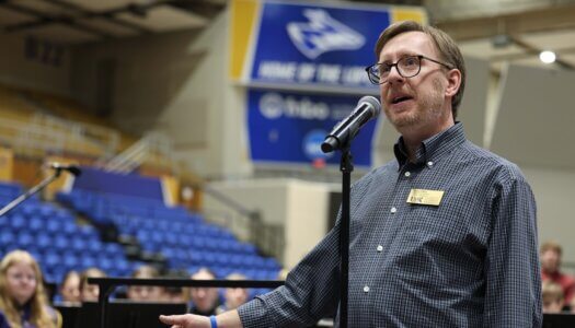 A music professor speaks at a concert at UNK.