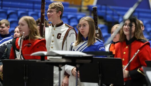 High school band students stand after performing a concert at UNK.