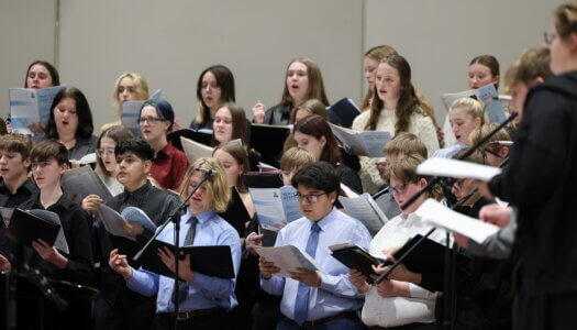 High school students sing at a choral concert at UNK.