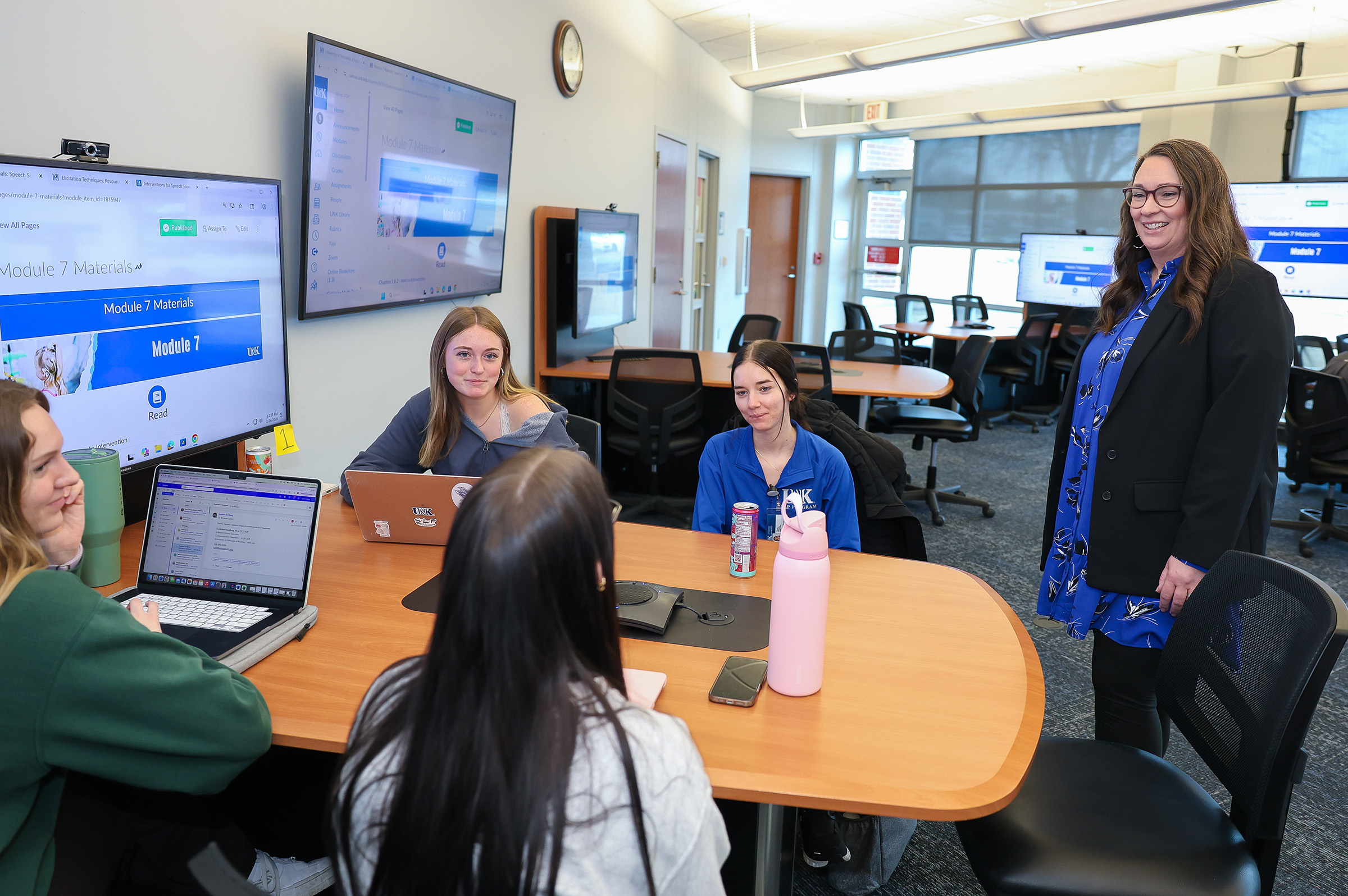 Whitney Schneider-Cline interacts with students in a UNK classroom.