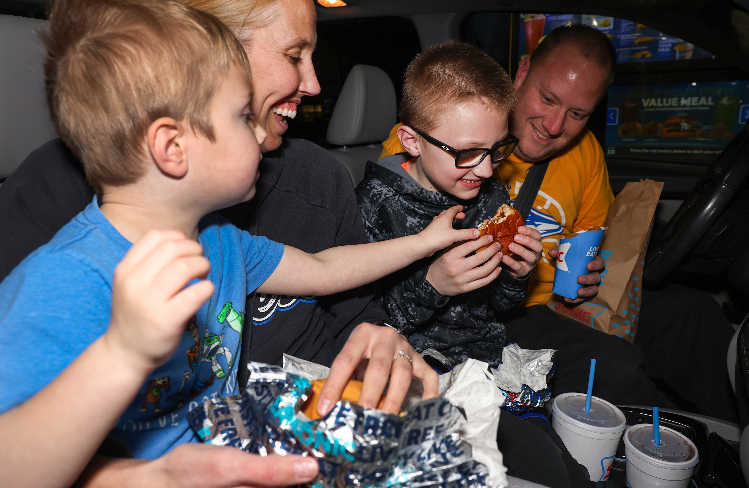 Drew and Nicole Johnson and their sons eat at the local Sonic Drive-In.