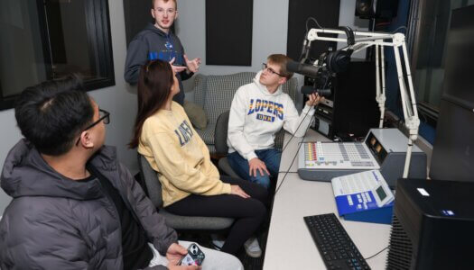 A student teaches his peers about the student radio station.