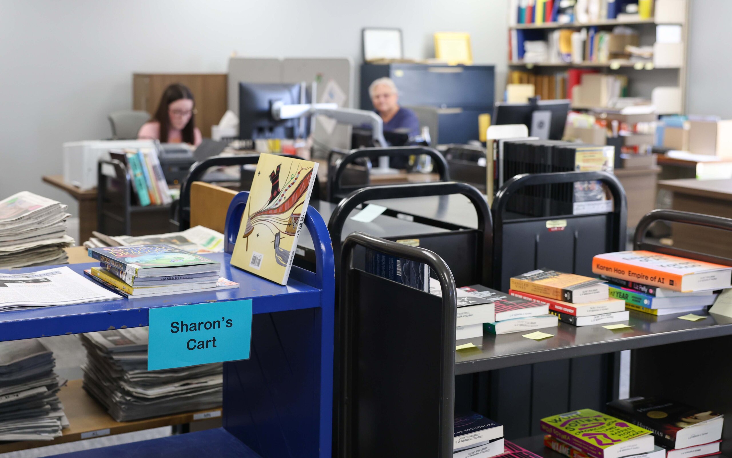 Books sit on a cart.