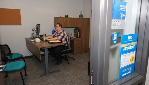 A man works on his computer in his office.