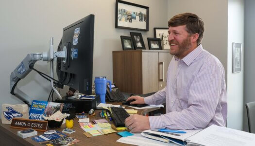 A man works on his computer in his office.