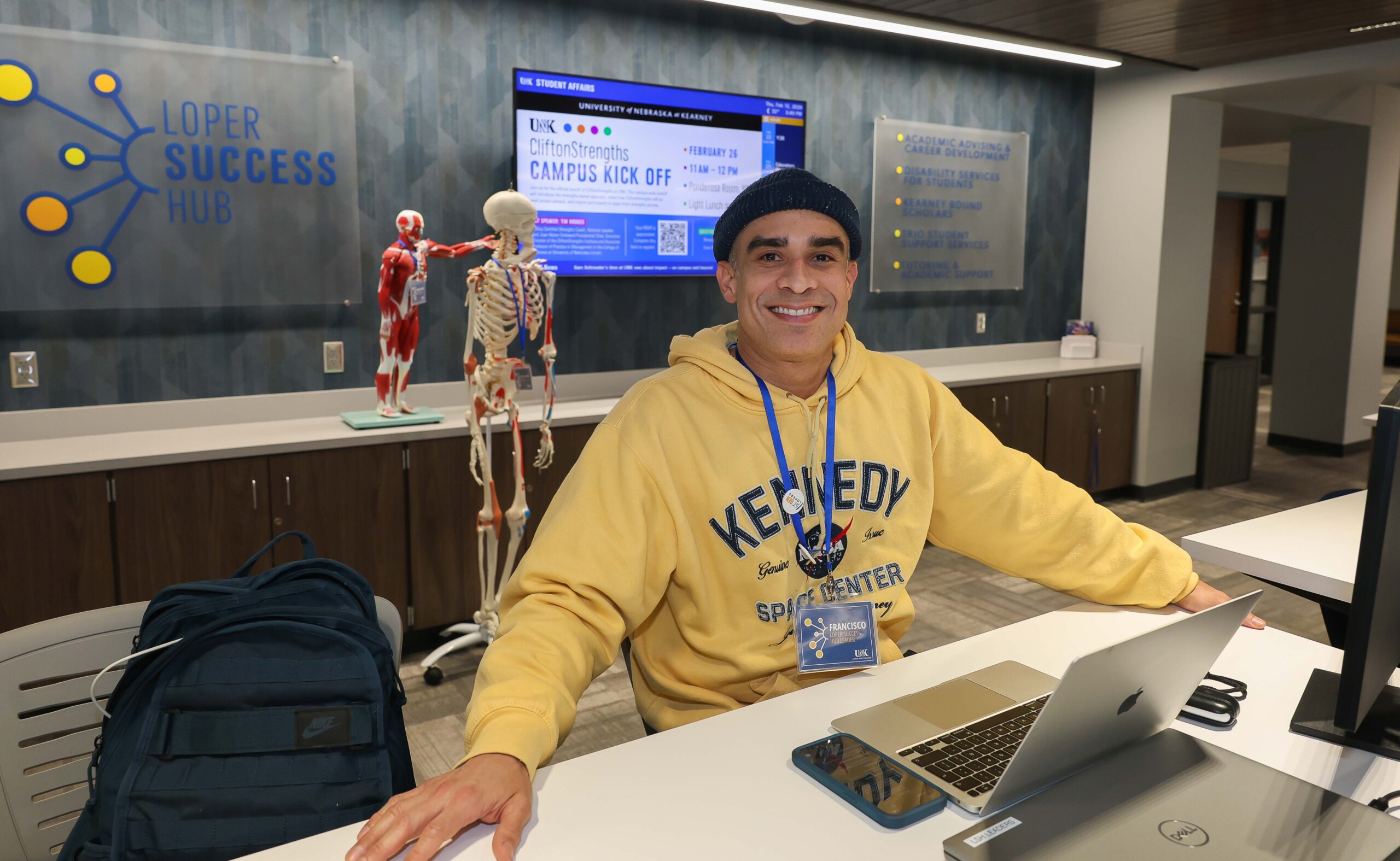 A student works at the front desk of the Loper Success Hub.