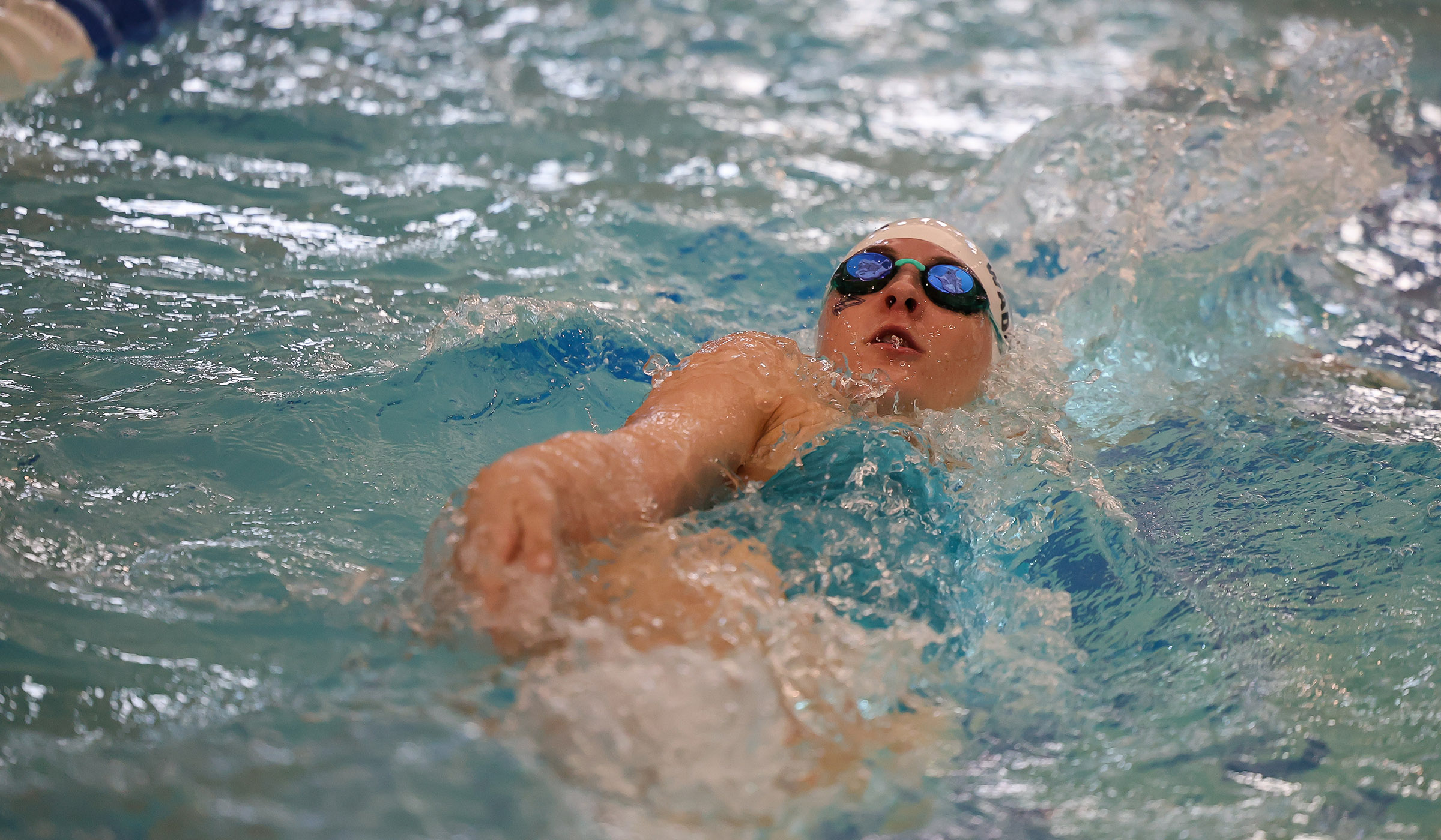 UNK swimmer Maggie Waddington competes in the backstroke.