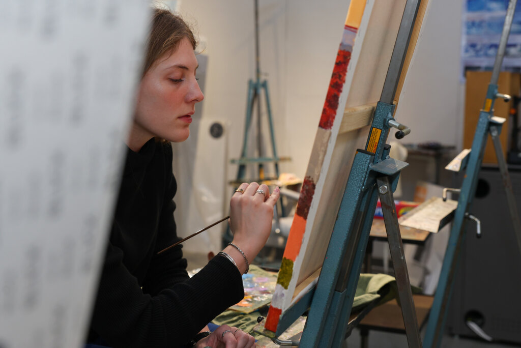 Maggie Waddington works on a project inside a UNK art studio.