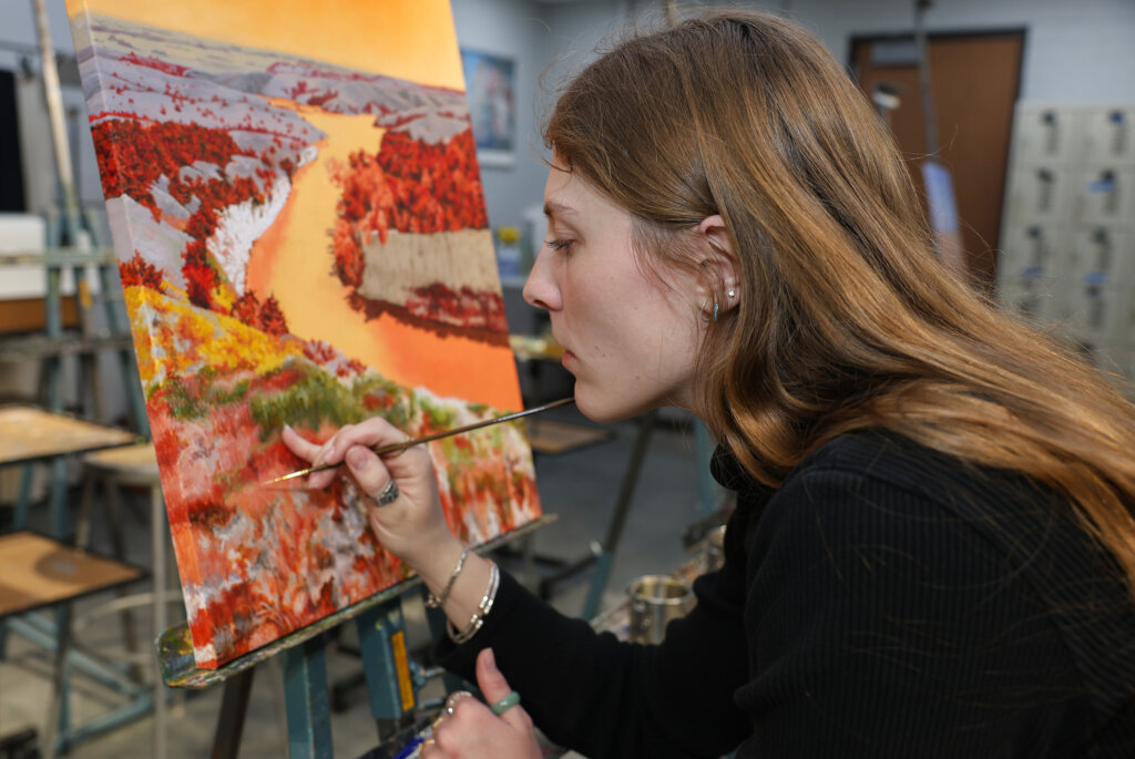 Maggie Waddington works on a project inside a UNK art studio.