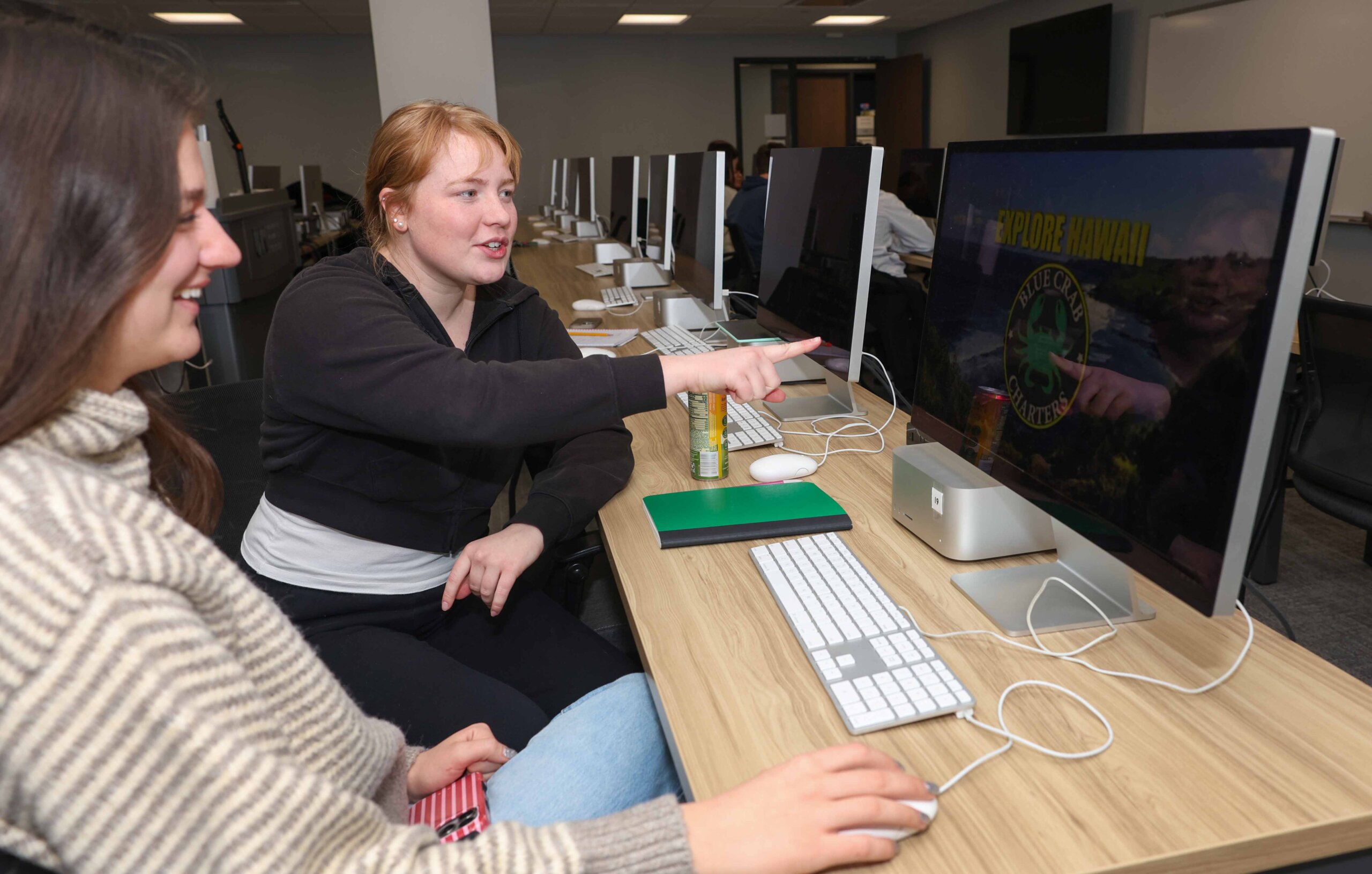 Students work on a design at a computer.