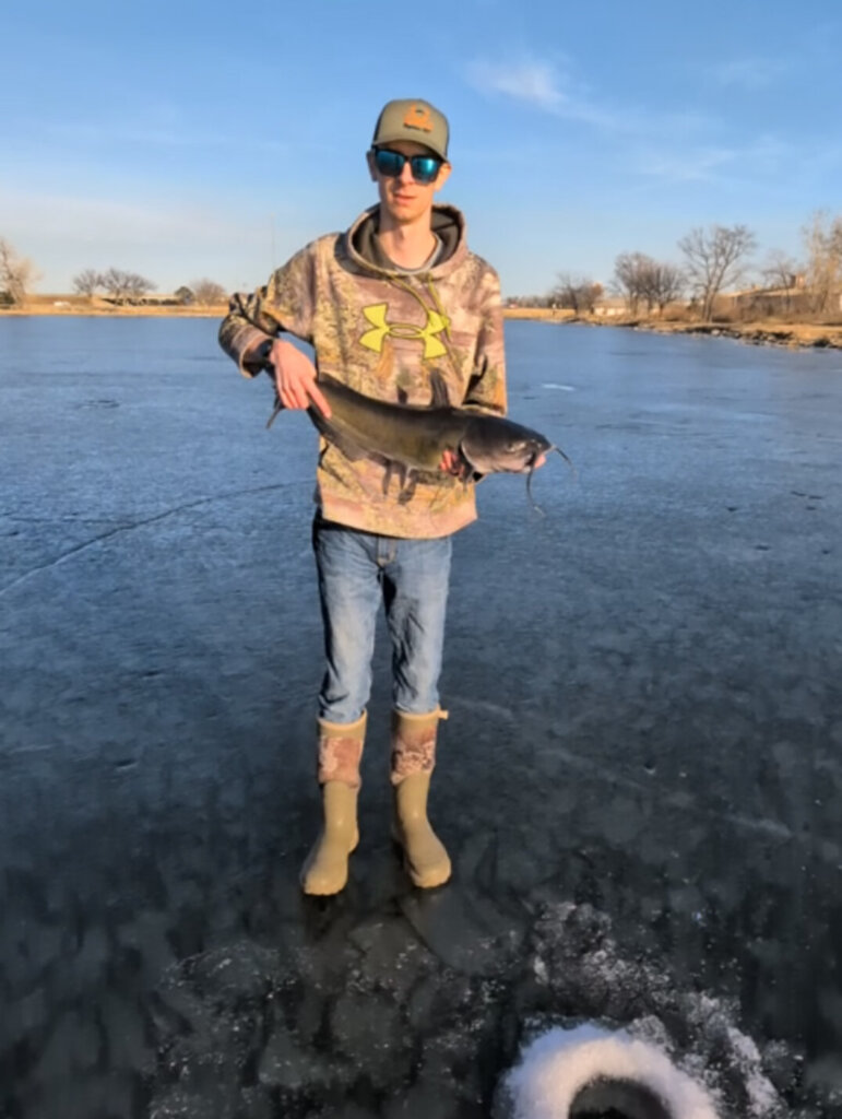 Robert Allison holds a catfish he caught ice fishing.