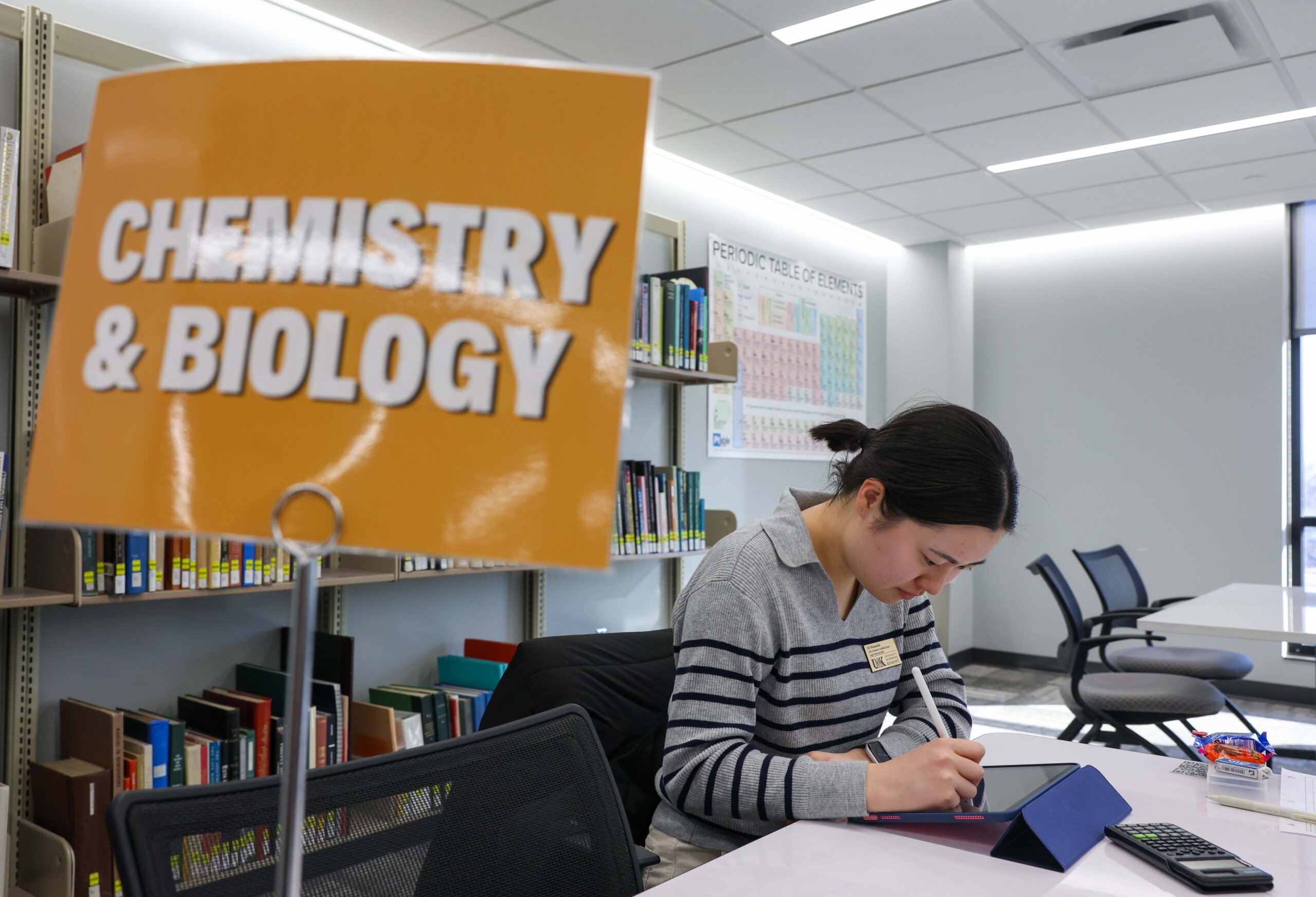 A student studies Chemistry and Biology in the library.