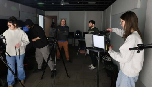 Students set up for a shoot in a video studio.