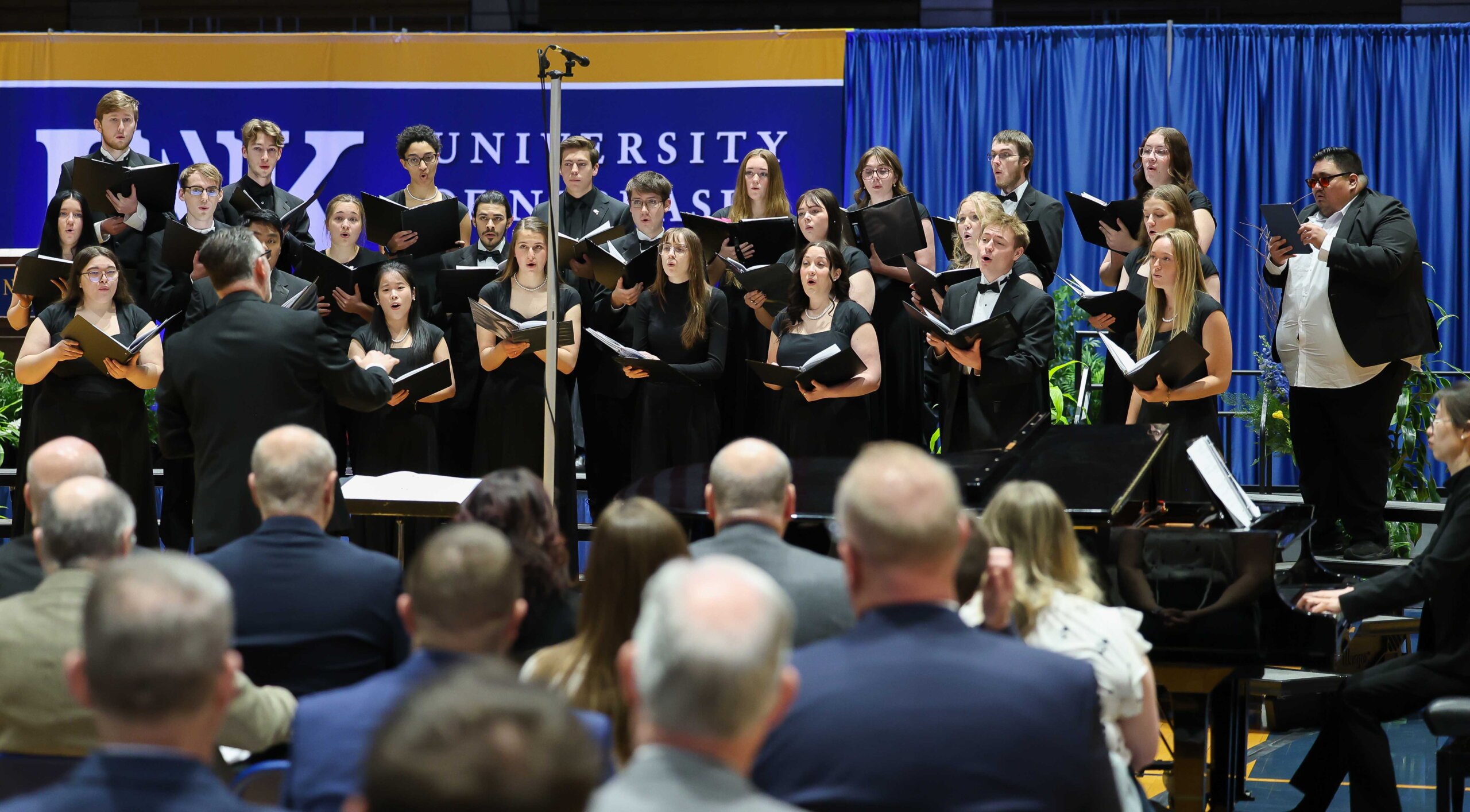 The UNK Choraleers perform during Friday's investiture ceremony.