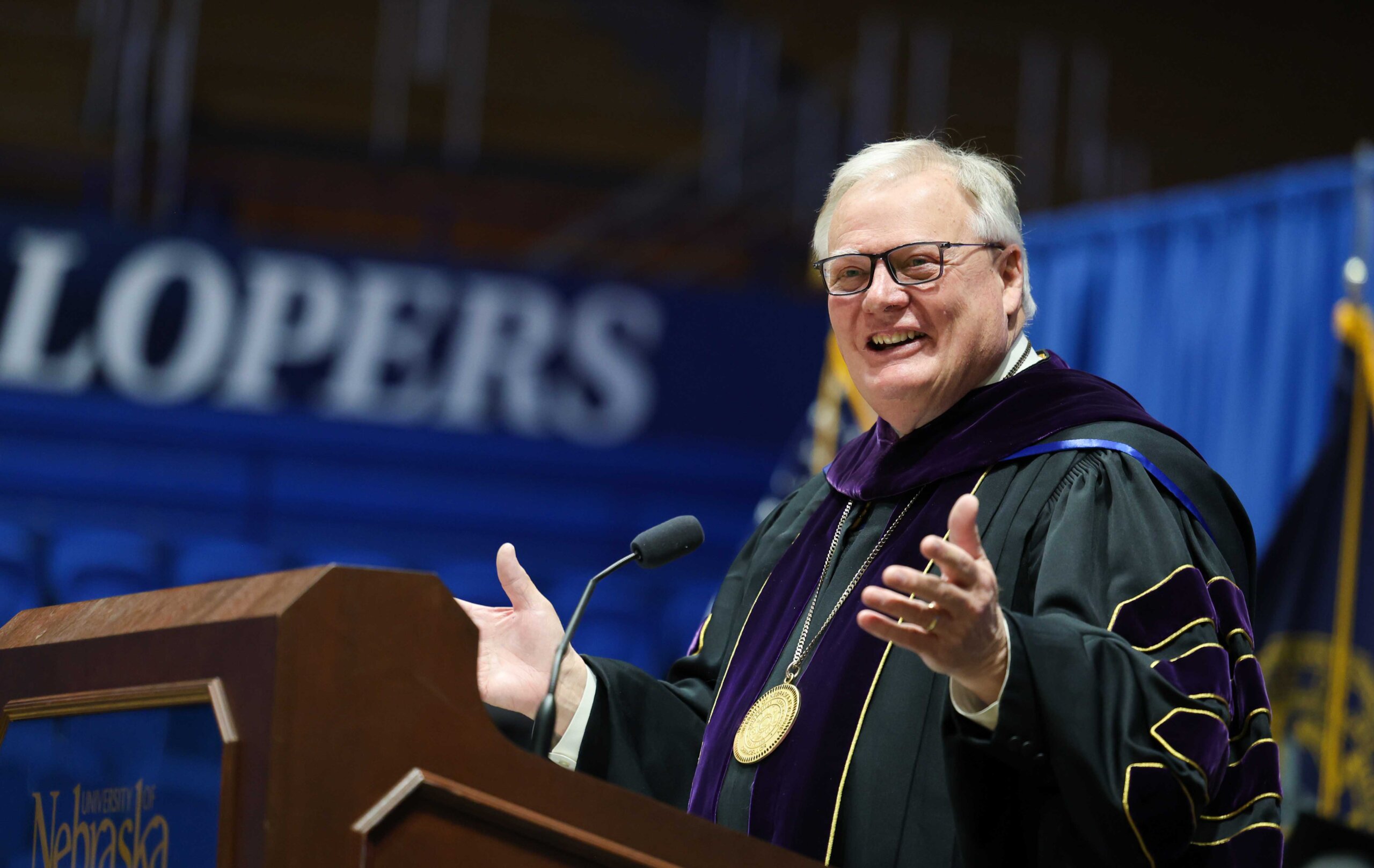 Former UNK Chancellor Doug Kristensen speaks Friday during the investiture ceremony for Neal Schnoor.