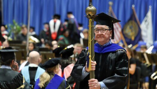 Gary Davis, former UNK director of bands, serves as marshal during the investiture.