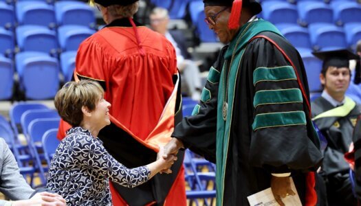 Teresa Schnoor and UNMC interim Chancellor H. Dele Davies.