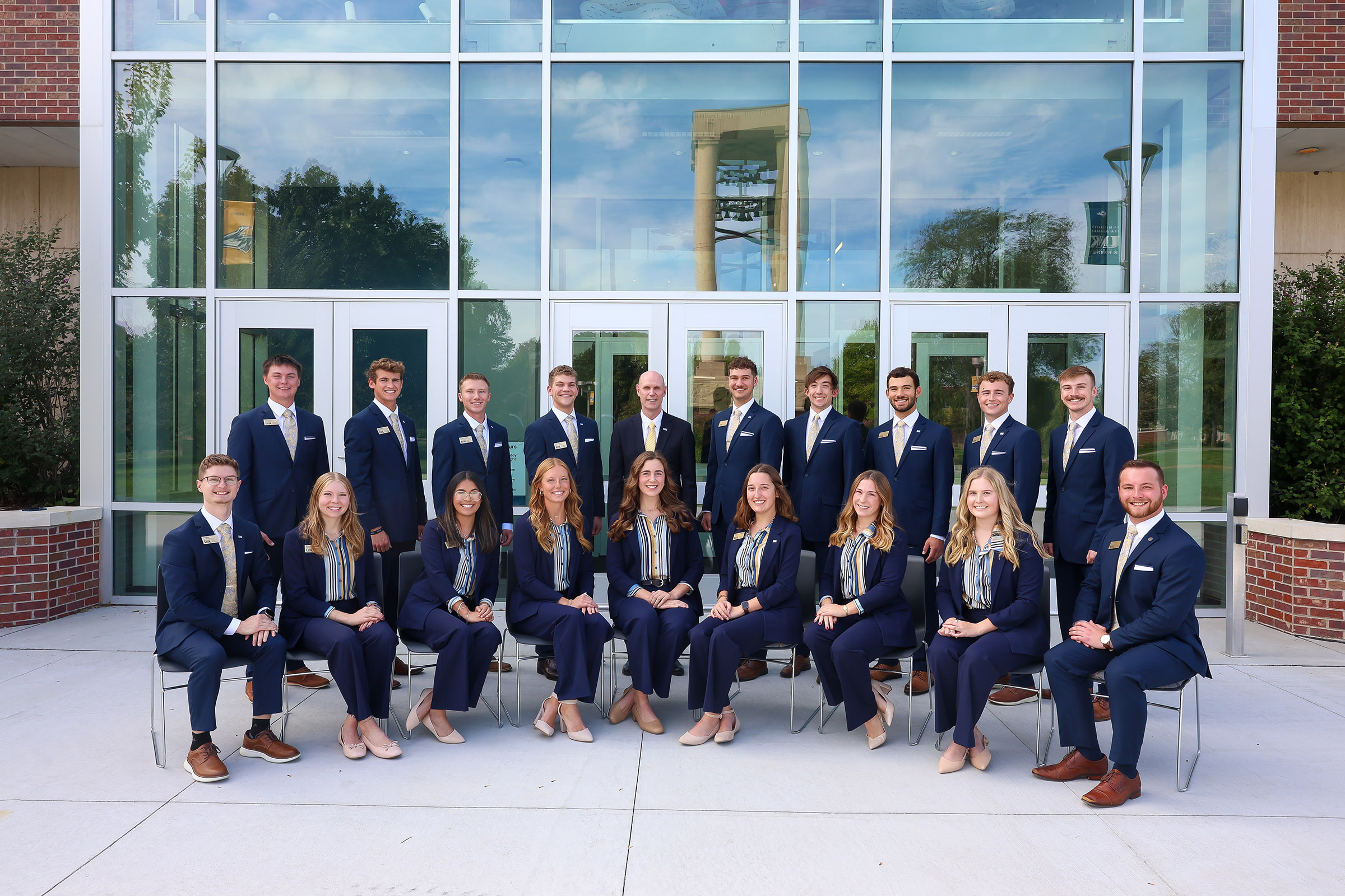 Eighteen students currently serve as Chancellor’s Ambassadors at UNK. They’re pictured with Chancellor Neal Schnoor outside Calvin T. Ryan Library.
