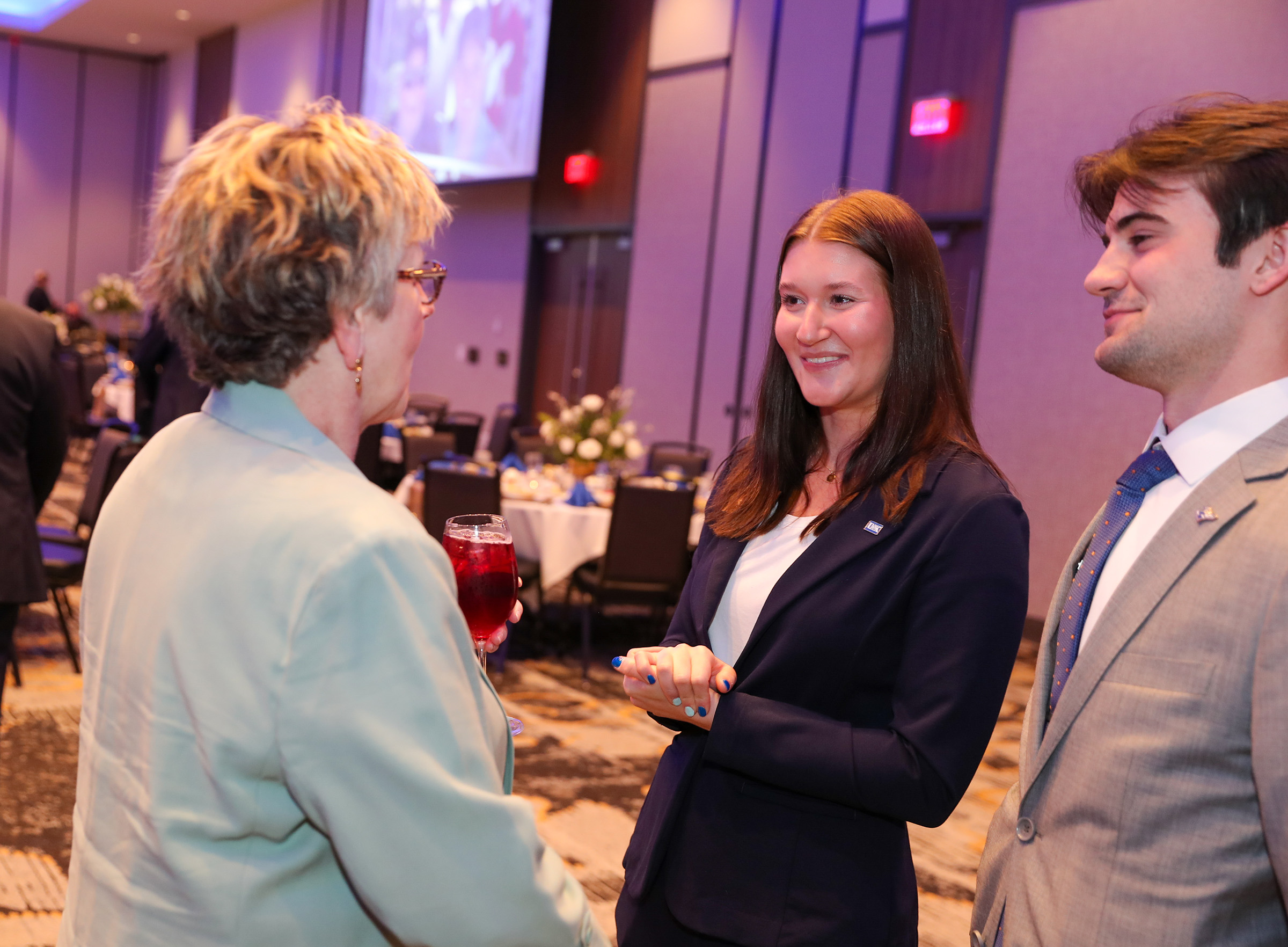 Chancellor's Ambassadors interact with a guest during former Chancellor Doug Kristensen's retirement party.