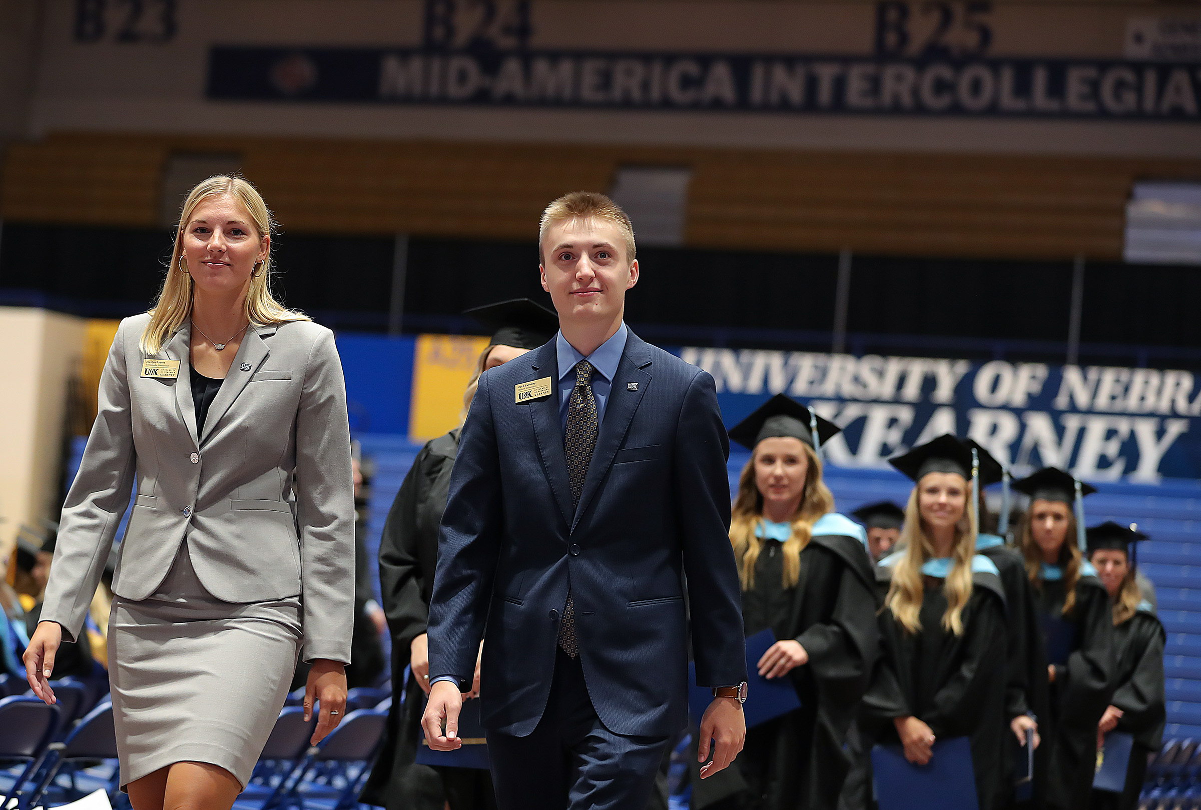 Chancellor's Ambassadors lead the processional during a UNK commencement ceremony.
