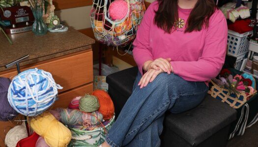 UNK junior Julia McKlem poses for a photo inside her room on campus.